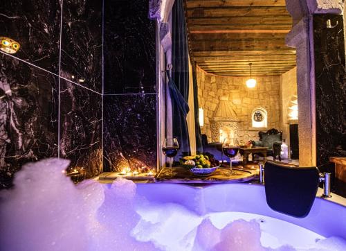 a bath tub in a room with a table at Historical Goreme House in Göreme