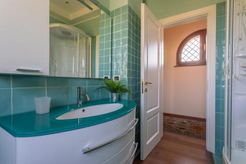 a bathroom with a sink and a mirror at VILLA TERRABIANCA - Premium Villas in Tortoreto Lido