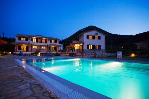 a large swimming pool in front of a house at Argovillas in Yenion