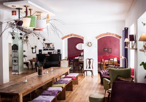 a living room with a wooden table and chairs at Naturschlosshotel Blumenthal in Aichach