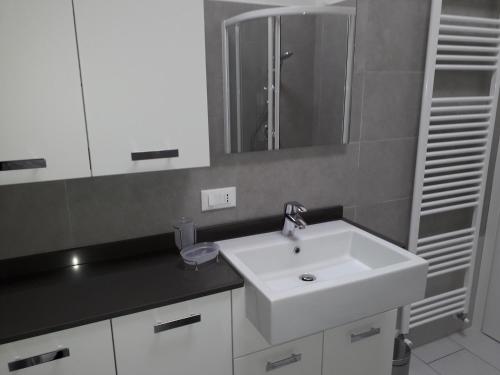 a bathroom with a white sink and a mirror at Casa Magosta in Malcesine