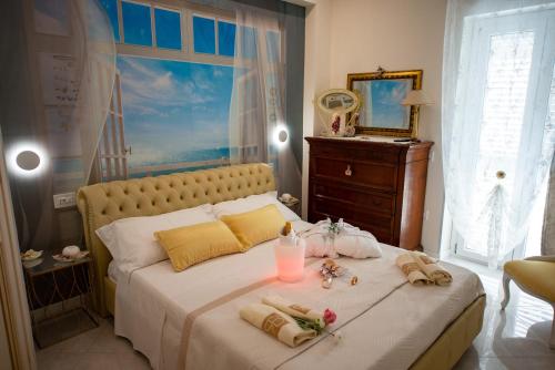 a bedroom with a large bed with towels on it at Le Radici Accomodation in Tropea