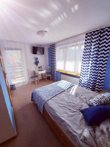 a bedroom with a bed and a desk in it at Pokoje gościnne "Trudziń-SKI" in Świeradów-Zdrój