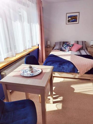 a bedroom with a bed and a table with a plate on it at Pokoje gościnne "Trudziń-SKI" in Świeradów-Zdrój