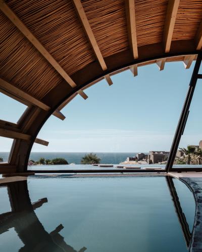 a view of a swimming pool from a house with a roof at Seaside A Lifestyle Resort - Adults Only in Agia Pelagia