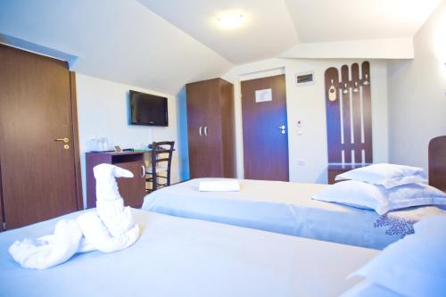 Postel nebo postele na pokoji v ubytování Hotel Piemonte