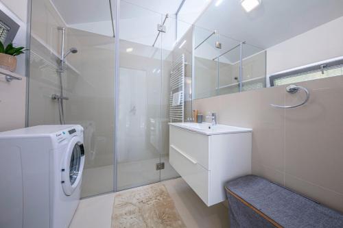 a bathroom with a washing machine and a sink at Villa del Mar in Mali Lošinj