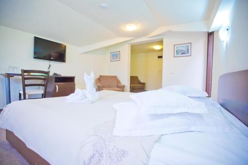 Postel nebo postele na pokoji v ubytování Hotel Piemonte