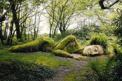a statue of a person laying in the grass at Shabby Shack near Charlestown & The Eden Project in St Austell
