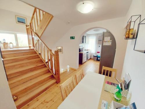 a room with a staircase and a living room at Pokoje gościnne "Trudziń-SKI" in Świeradów-Zdrój