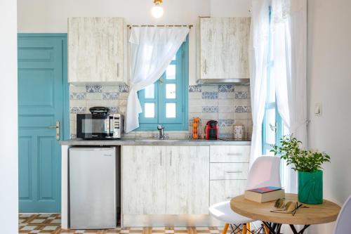 a small kitchen with a sink and a microwave at THE SHIP in Lefkos Karpathou