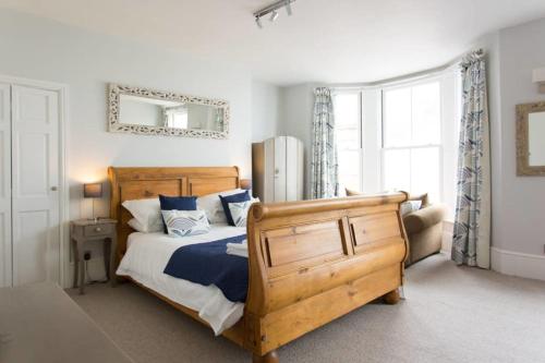 a bedroom with a wooden bed and a window at Seaside Retreat in North Bay - with parking in Scarborough