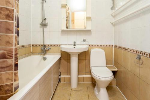 a bathroom with a toilet and a sink and a bath tub at ApartLux Novoarbatskaya Superior 2 in Moscow