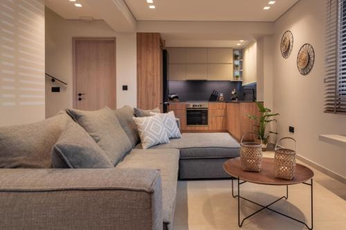 a living room with a couch and a table at Villa Verde - Heated Pool with Stunning Views, by ZanteWize in Kallithea