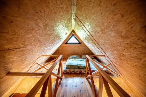 a room with a bed in the middle of a building at Pas Kaziuką namukas in Palūšė