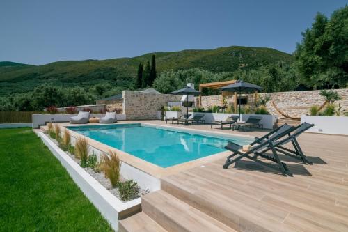 a backyard with a swimming pool and a wooden deck at Villa Verde - Heated Pool with Stunning Views, by ZanteWize in Kallithea