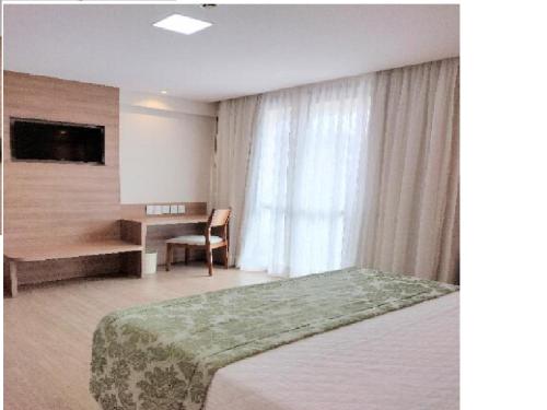 Un pat sau paturi într-o cameră la Condomínio Vista Azul hotel