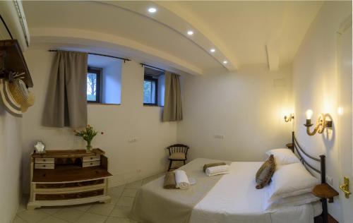 a bedroom with two beds and a window at Monastero San Silvestro in Cortona