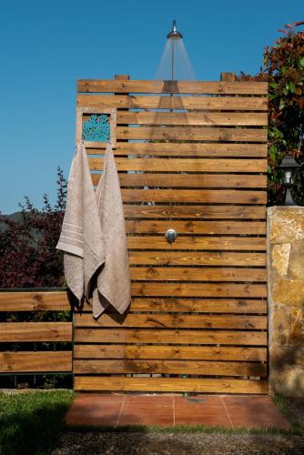 a wooden fence with two towels hanging on it at Dandy Villas Nea Roda - Melodic Waves - Private - Pool - Parking - Cellar in Nea Roda