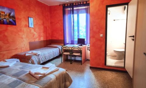 Postel nebo postele na pokoji v ubytování Hotel Violetta