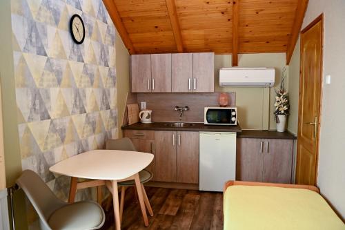 a small kitchen with a small table and a small table at Angéla Vendegház in Tokaj