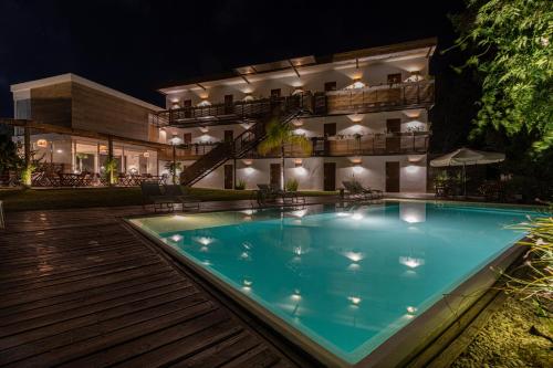a swimming pool in front of a building at night at Live Hotel Boutique (Adults only) in Punta del Este