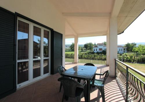 a patio with a table and chairs on a porch at Villa Green - Irpinia in Venticano