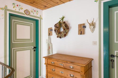 a room with a wooden dresser and a door at Tyrol Appartements in Ehrwald