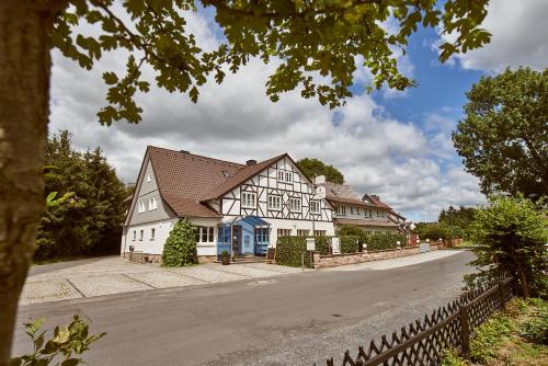 a row of houses on a street with a fence at Das Landhotel am Trätzhof Fulda in Fulda