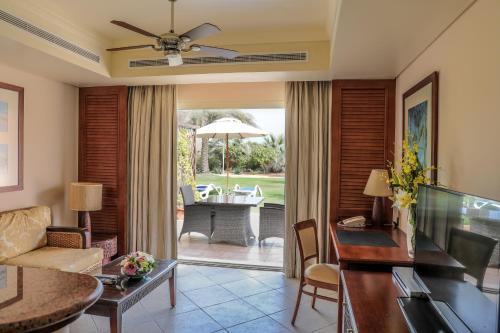 a living room with a couch and a table at Danat Jebel Dhanna Resort in Jebel Dhanna