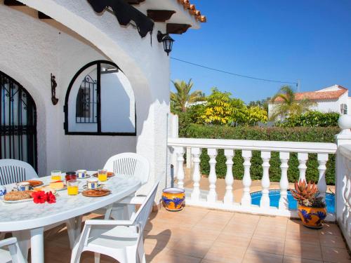 a patio with a table and chairs on a balcony at Holiday Home Mara by Interhome in Casas de Torrat