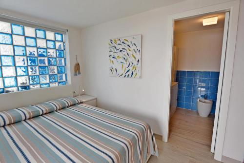 a bedroom with a bed and a window at La Perla del Golfo in Capoliveri