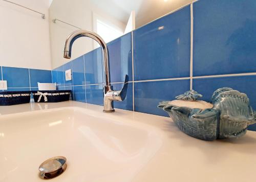 a bathroom with a large tub with a faucet at La Perla del Golfo in Capoliveri