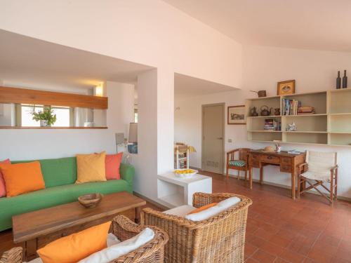 un soggiorno con divano e sedie verdi di Apartment La Vigna Top by Interhome a Palau