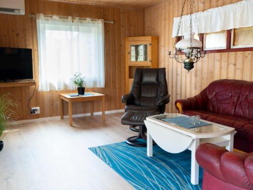 a living room with a couch and a chair at Holiday Home Raumelen - FJS018 by Interhome in Balestrand