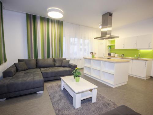 a living room with a couch and a table and a kitchen at Apartment Techno-Park Villach by Interhome in Sankt Ulrich