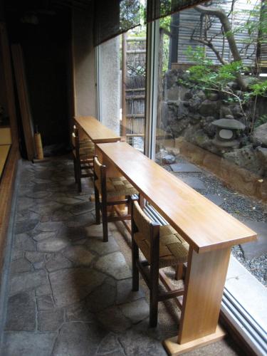 two wooden tables and chairs on a patio at Hotel Edoya in Tokyo