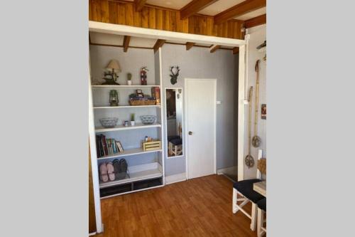 a room with white shelves and a door at Refugio acogedor en Farellones in Santiago