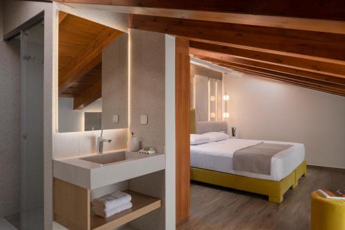 a bedroom with a bed and a sink in a room at Amphi Exclusive Residence in Somatás