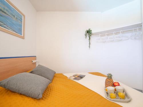 a bedroom with a bed with a tray of fruit on it at Apartment Golf de la Nivelle-4 by Interhome in Ciboure