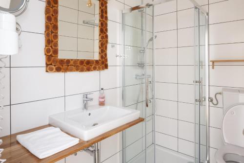 a bathroom with a sink and a shower at Pension Laubenhof in Mörbisch am See