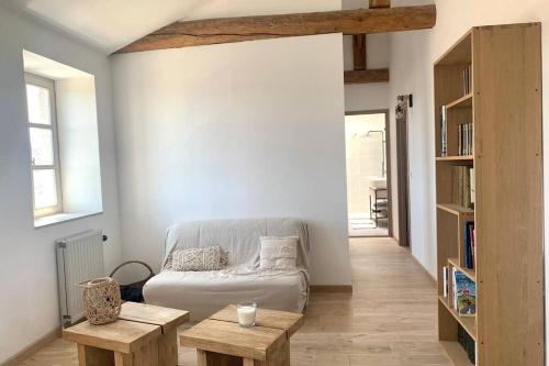 a living room with a couch and two tables at La providence, surplombant la ville in Montbrison