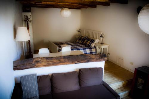 sala de estar con sofá y cama en Medieval Hamlet Malpertus, en Bobbio Pellice