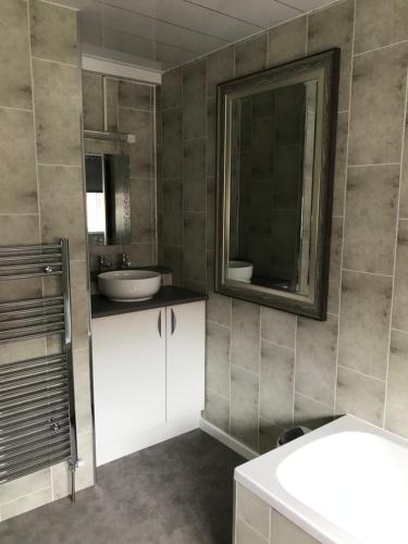 a bathroom with a sink and a mirror at The Oxfordshire in Blackpool
