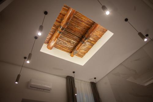 a ceiling with three lights and a wooden ceiling at 4heavens_naples in Naples