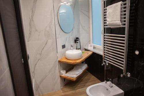 a bathroom with a sink and a mirror at 4heavens_naples in Naples