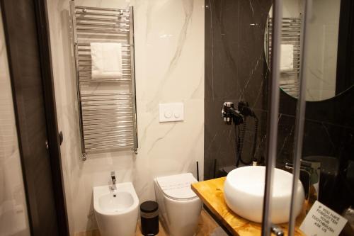 a bathroom with a white sink and a toilet at 4heavens_naples in Naples