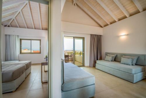 a bedroom with two beds and a table at Stefan Village Hotel in Agia Marina Nea Kydonias