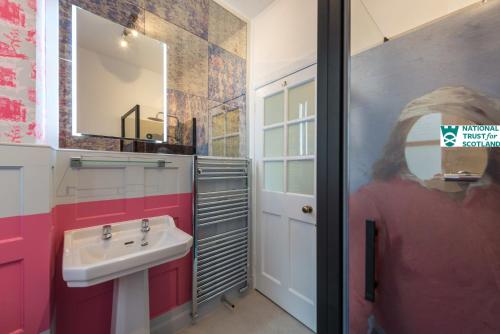 a bathroom with a sink and a mirror at Johnstone Apartment by The National Trust Scotland in Edinburgh