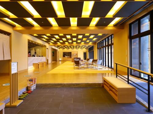 a lobby of a building with yellow ceilings at Onyado Nono Kanazawa in Kanazawa